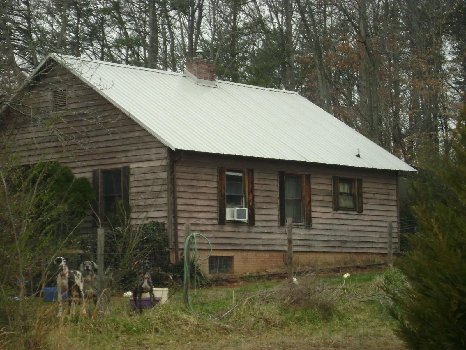 White metal roof on an old wood sided farmhouse, from a Metal Roof Installation job in Metuchen
